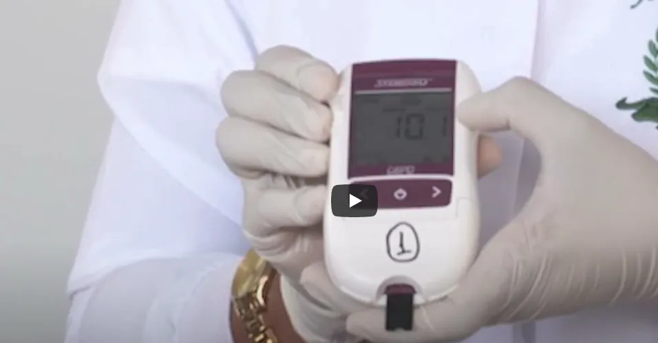 Gloved hands holding medical device.